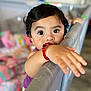 Arliss Selah joined the competition — help win amazing prizes! blurred_background, bracelet, child, clothing, colorful, curious, cushion, cute, expression, face, hand, home, indoor, person, playpen, soft_focus, toddler, toy, wide_eyes, young_child