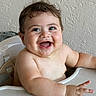 Damian is registered to the contest to win money with this photo: baby, child, happy, smiling, high_chair, wet_skin, tooth, face, arms, hand, indoor, person, cute, infant, sitting, expression, close_up, skin, naked_shoulders, background