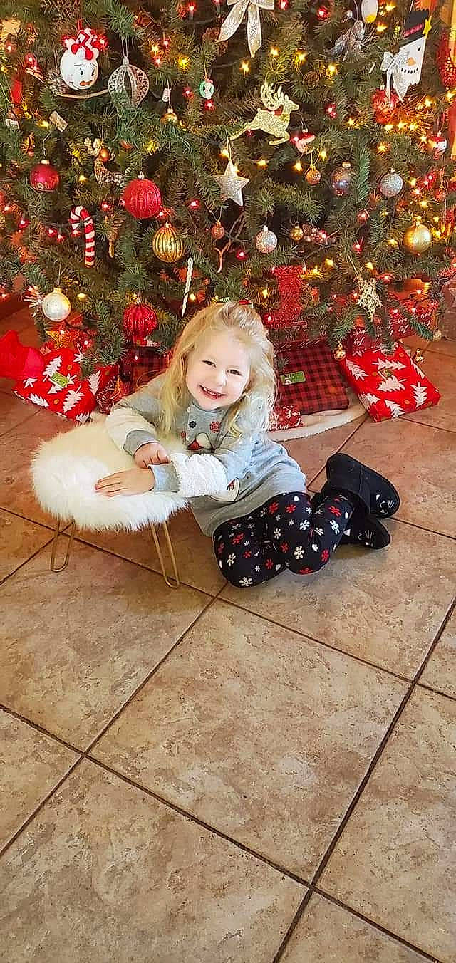 Audra joined the competition — help win amazing prizes! christmas_decoration, christmas_ornament, christmas_tree, event, fawn, flooring, happy, head, holiday, holiday_ornament, human_body, joy, ornament, people, person, plant, red, smile, snapshot, toddler
