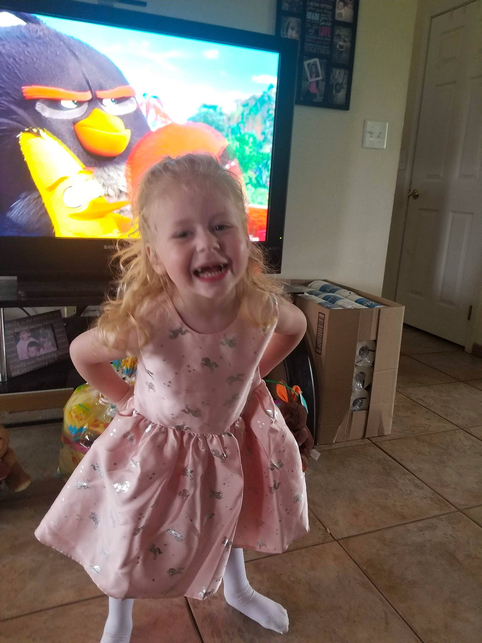 Audra is registered to the contest to win money with this photo: art, baby_toddler_clothing, child, costume, display_device, door, event, flat_panel_display, flooring, fun, happy, human_body, joy, led_backlit_lcd_display, person, play, room, smile, standing, television