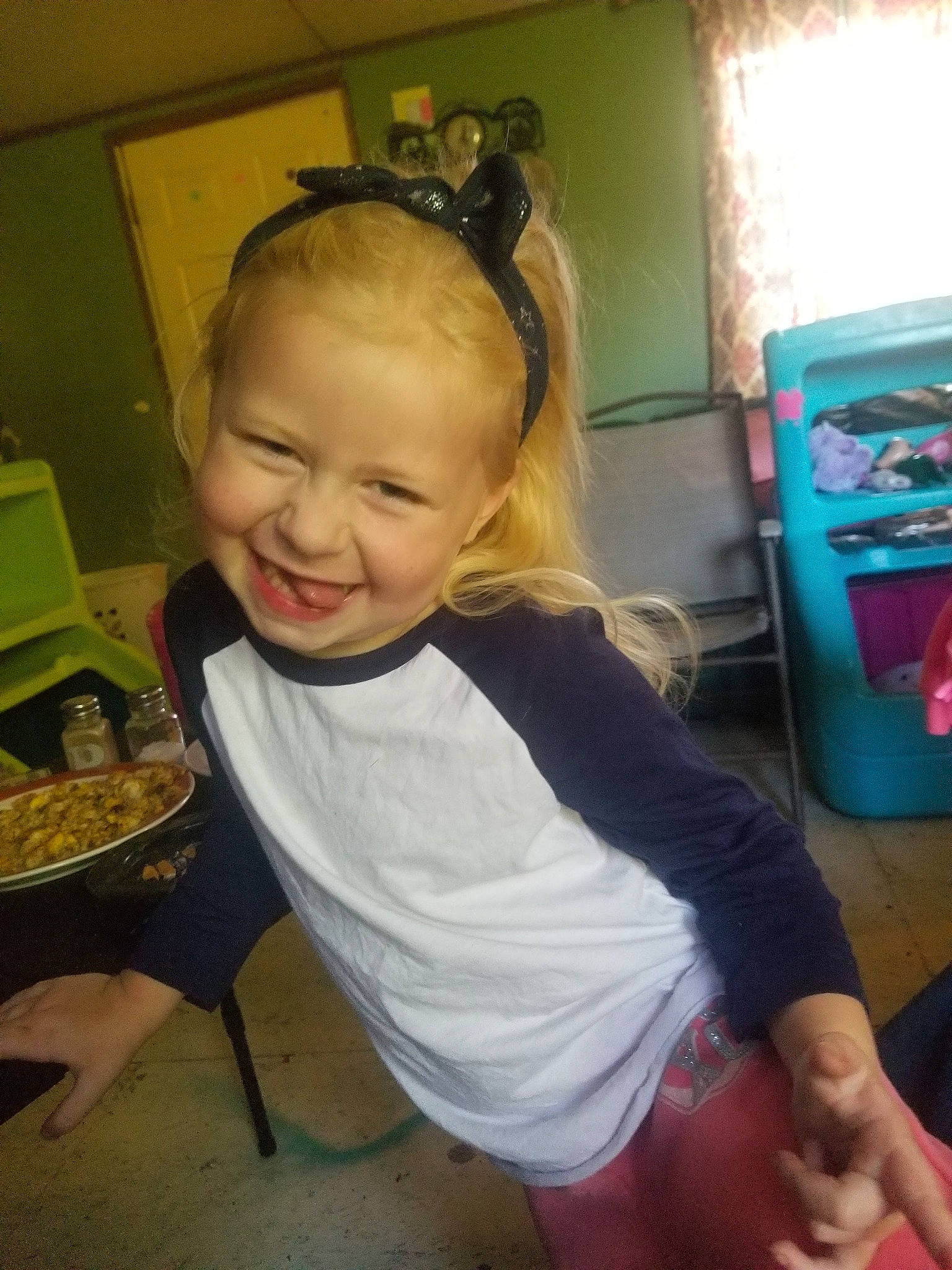 Audra joined the competition — help win amazing prizes! audio_equipment, blond, chair, child, ear, flooring, fun, hair, head, human_leg, joy, kitchen_appliance, knee, machine, person, room, sitting, smile, t_shirt, thigh