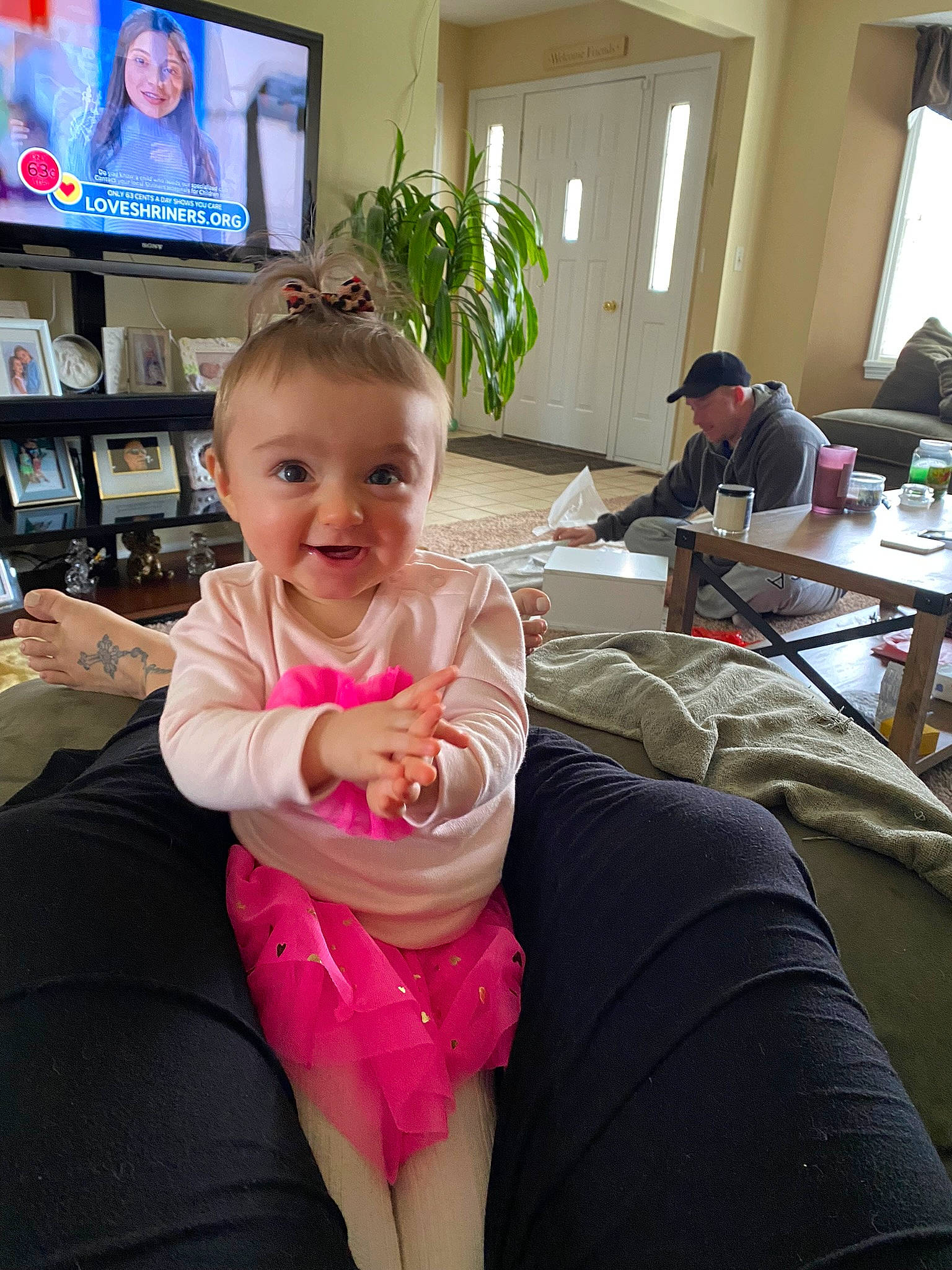 Mackenzie joined the competition — help win amazing prizes! arm, baby, chair, comfort, flooring, fun, furniture, happy, headwear, houseplant, joy, lap, leisure, person, plant, shelf, smile, table, tableware, television