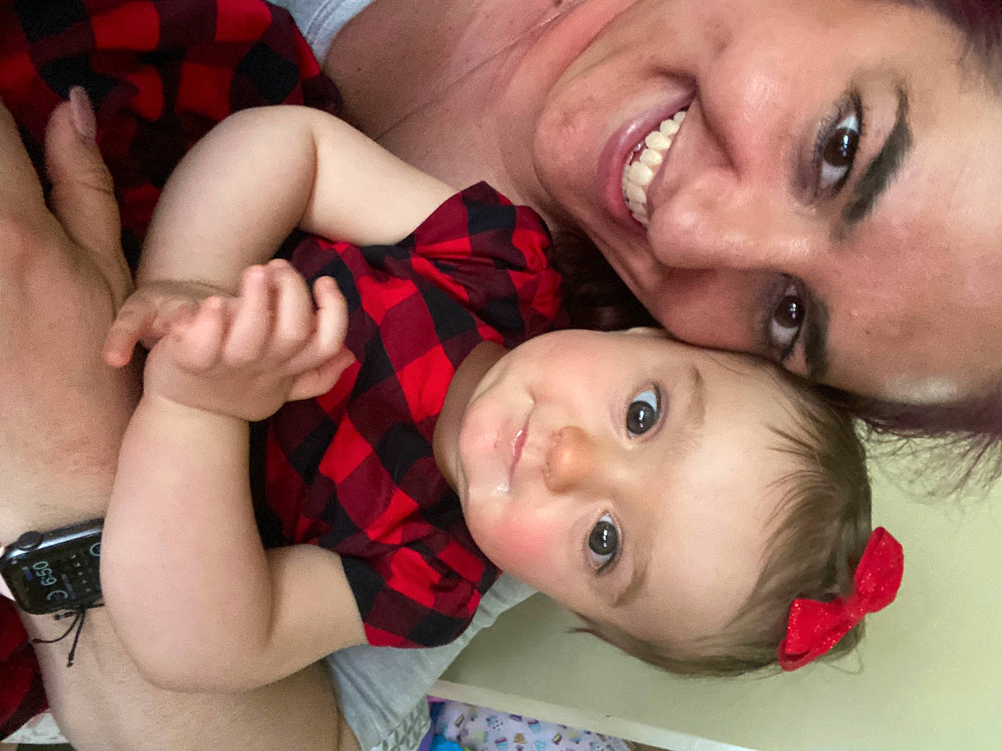 Mackenzie is registered to the contest to win money with this photo: cheek, child, eyelash, facial_expression, finger, gesture, hand, happy, interaction, iris, joy, lip, mouth, nose, organ, person, plaid, red, skin, smile