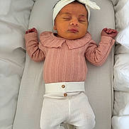 Mila participe au concours pour gagner de l'argent avec cette photo : newborn, baby, sleeping, headband, pink_clothing, white_pants, lace, cushion, bedding, infant, peaceful, cute, resting, indoors, portrait, person, soft, child, sleep, cozy