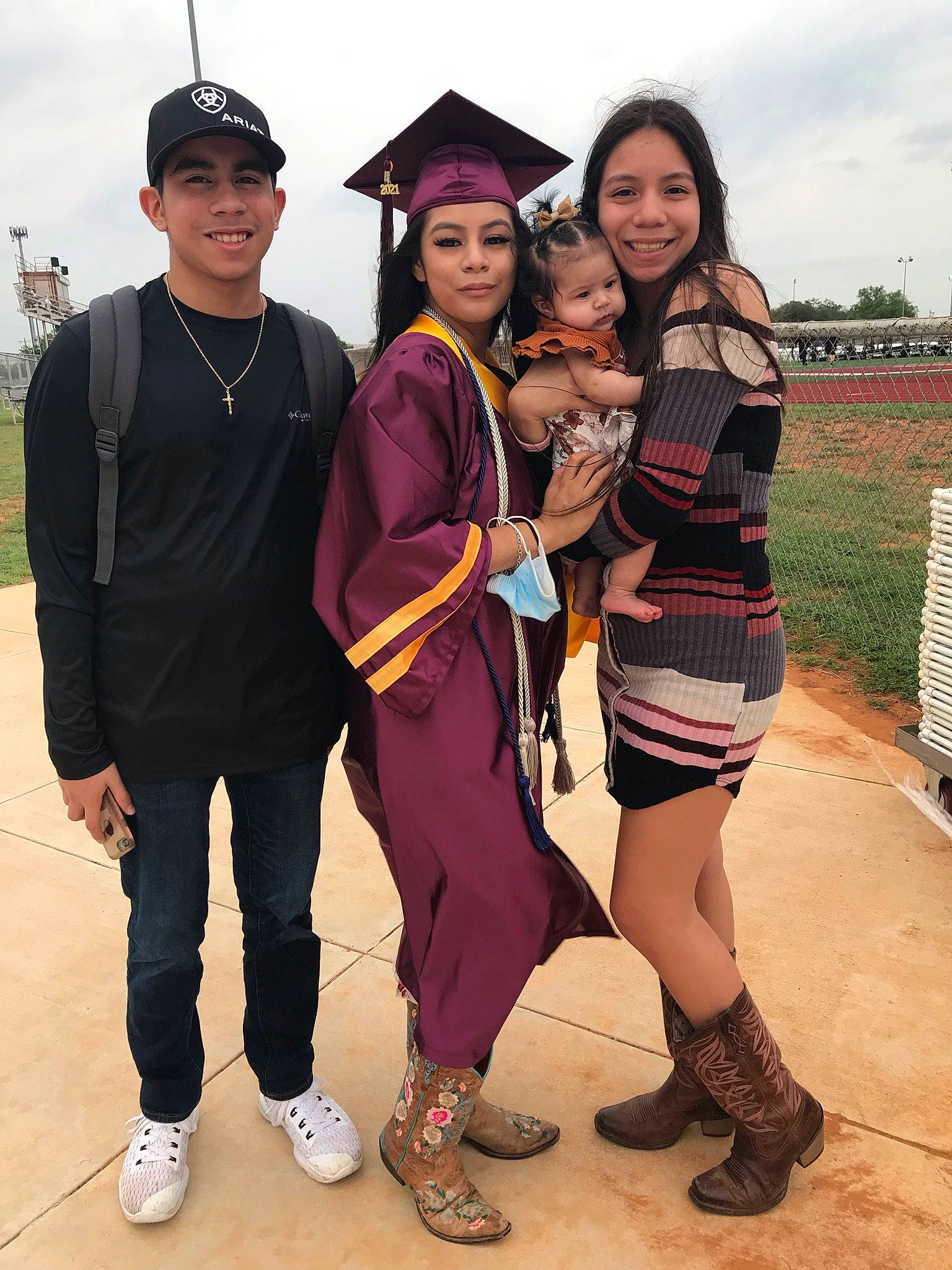 Annalisa is registered to the contest to win money with this photo: event, face, fashion_design, footwear, friendship, fun, happy, hat, head, headwear, joy, leisure, mortarboard, people, person, sandal, shoe, sky, smile, sneakers