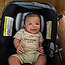 Julien joined the competition — help win amazing prizes! baby, smiling, car_seat, child, infant, clothing, shirt, sitting, happy, indoors, seatbelt, fabric, cute, toddler, person, head, face, skin, hand, foot