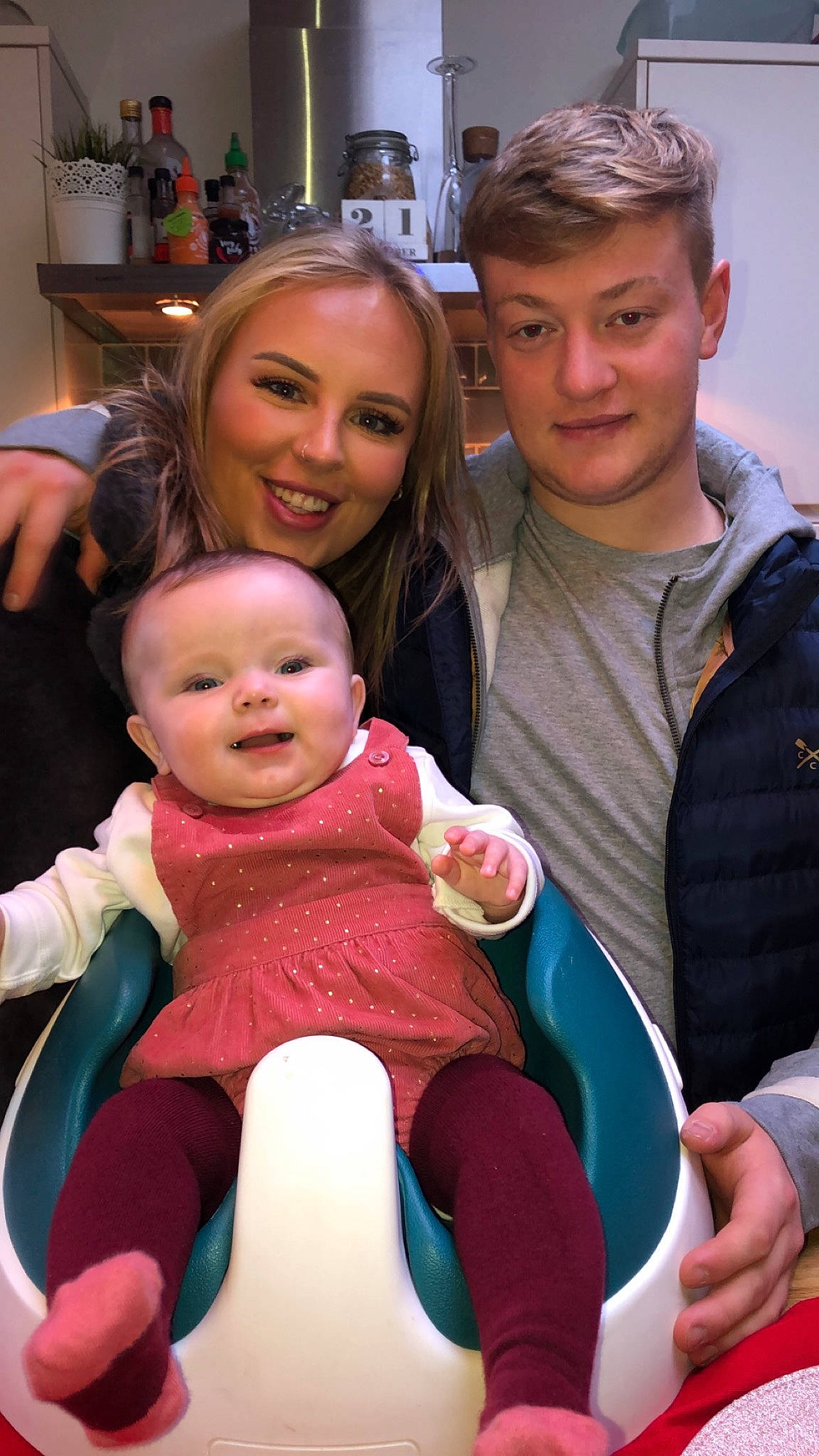 Iyla is registered to the contest to win money with this photo: arm, baby, child, daughter, family, fun, headwear, joy, lap, leg, mother, people, person, product, sitting, skin, smile, toddler, vacation