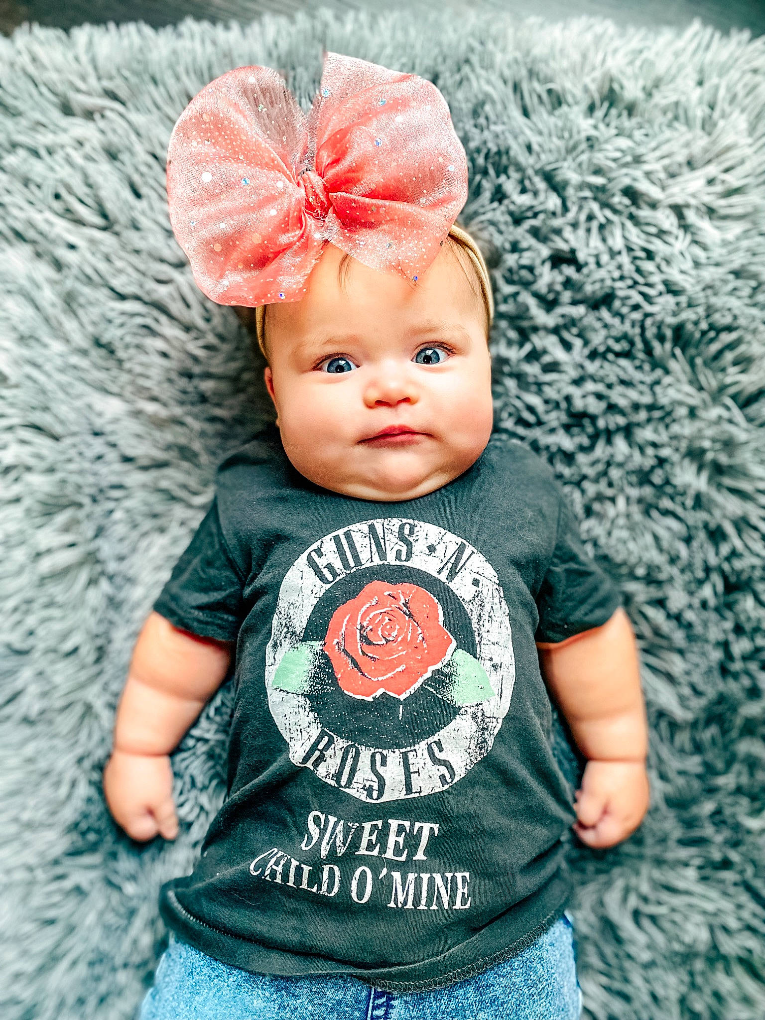 Phoenix is registered to the contest to win money with this photo: baby, baby_toddler_clothing, cap, clothing, cool, costume_hat, dress, eye, eyelash, grey, happy, head, outerwear, person, photograph, pink, product, sleeve, t_shirt, textile