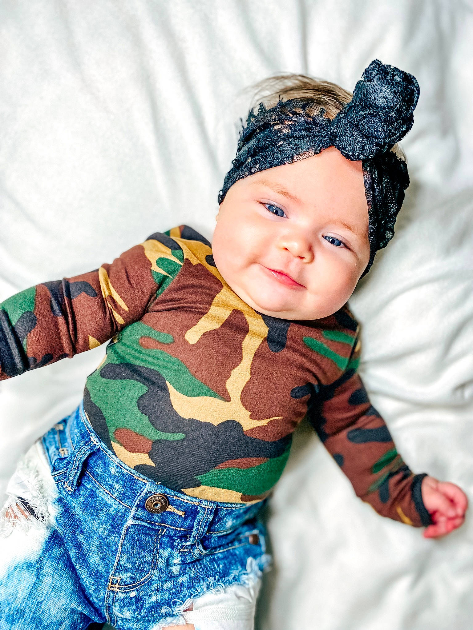 Phoenix is registered to the contest to win money with this photo: baby, baby_toddler_clothing, cap, chest, child, eye, face, fun, happy, headwear, human_body, iris, organ, pattern, person, skin, sleeve, smile, standing, textile