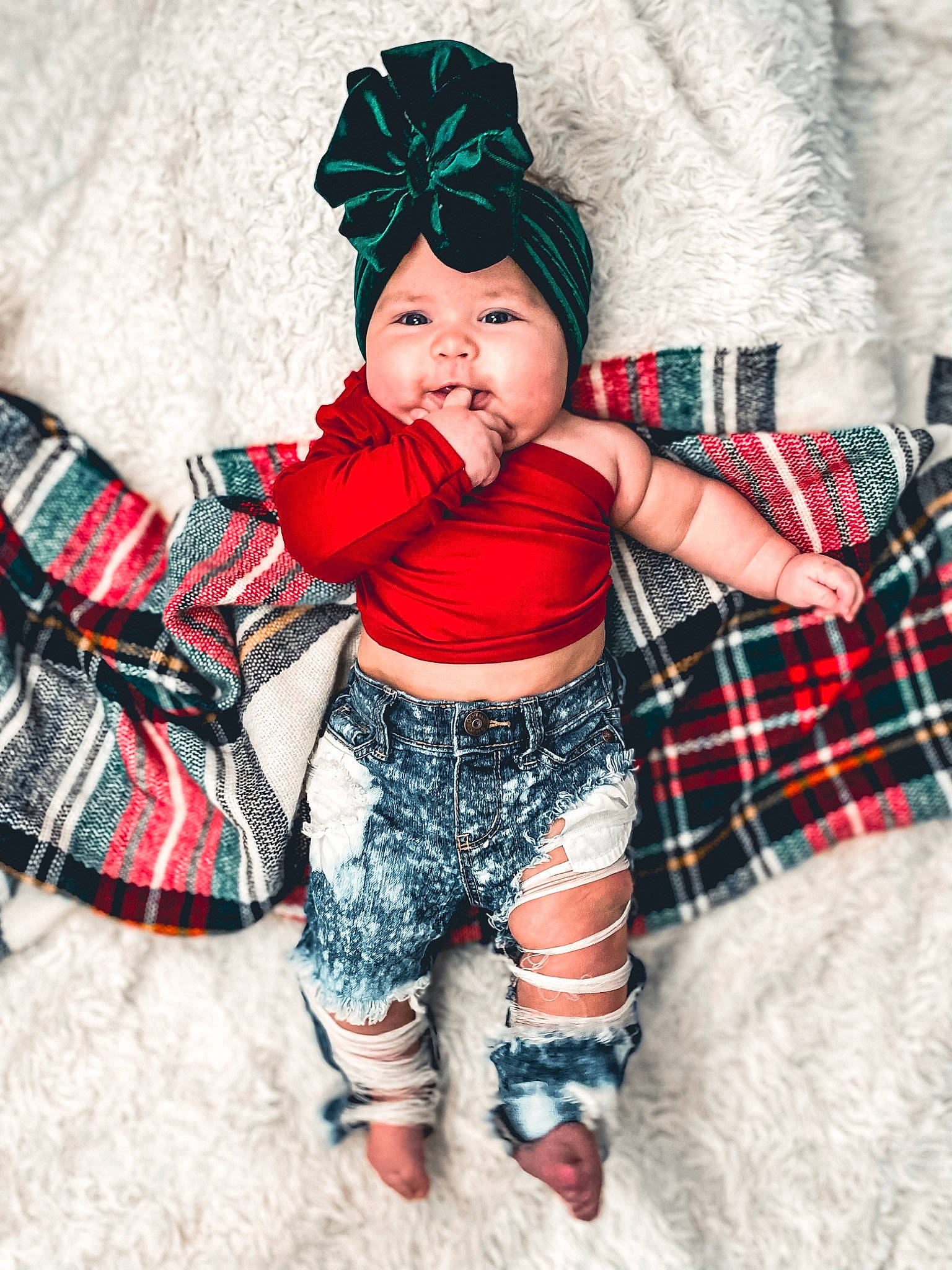 Phoenix is registered to the contest to win money with this photo: abdomen, baby, baby_products, baby_toddler_clothing, cap, child, costume_hat, fashion_accessory, happy, headgear, headwear, pattern, person, plaid, play, sitting, sleeve, sock, tartan, textile