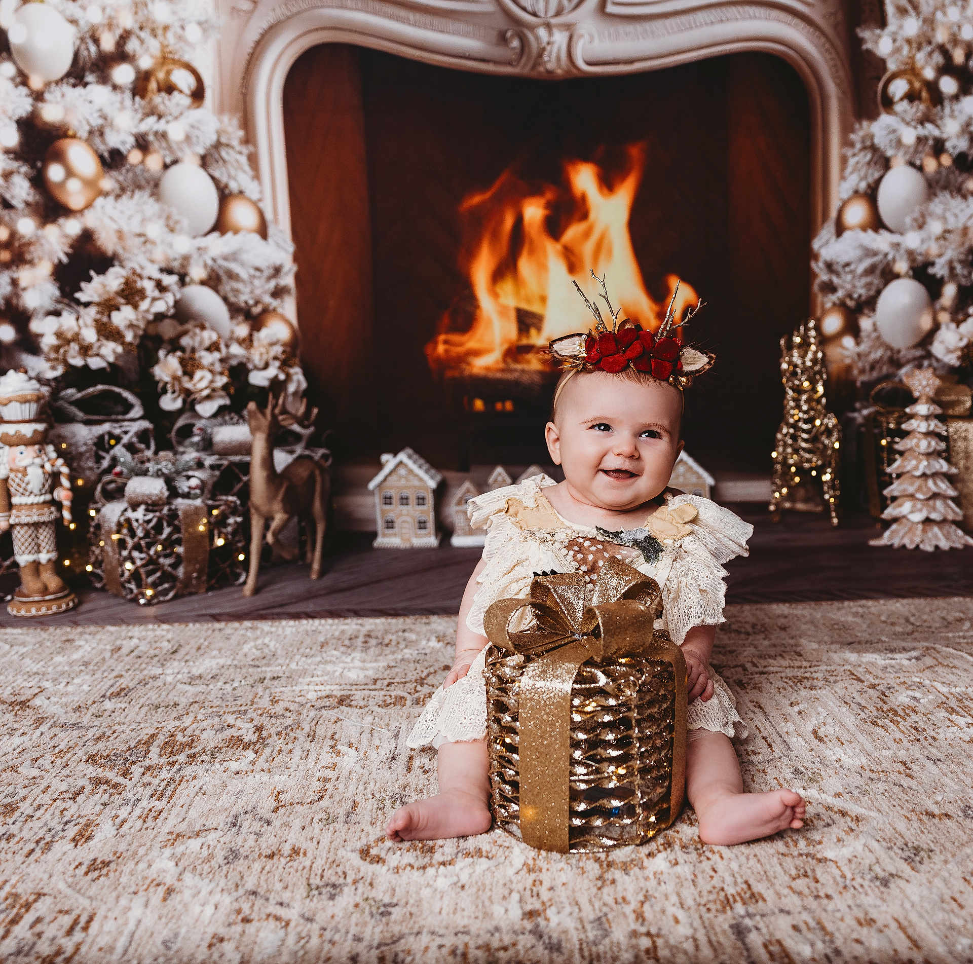Brianna joined the competition — help win amazing prizes! baby, child, gift_box, christmas_decorations, fireplace, holiday, festive, reindeer_headband, lace_dress, carpet, smiling, indoor, christmas_tree, nutcracker, wood_floor, decorative_lights, holiday_season, cozy, winter, smile