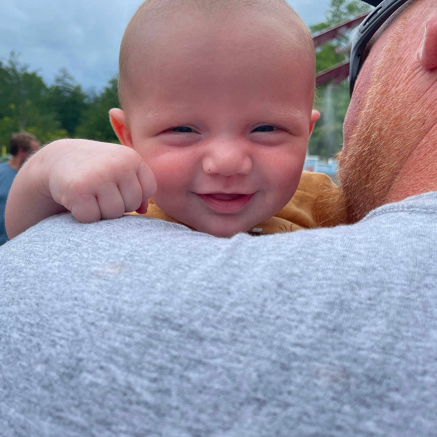 Ryett joined the competition — help win amazing prizes! adult, baby, casual_clothing, child, closeup, cloudy_sky, expression, face, fist, fun, hand, happy, head, nature, outdoor, person, portrait, shoulder, smile, trees