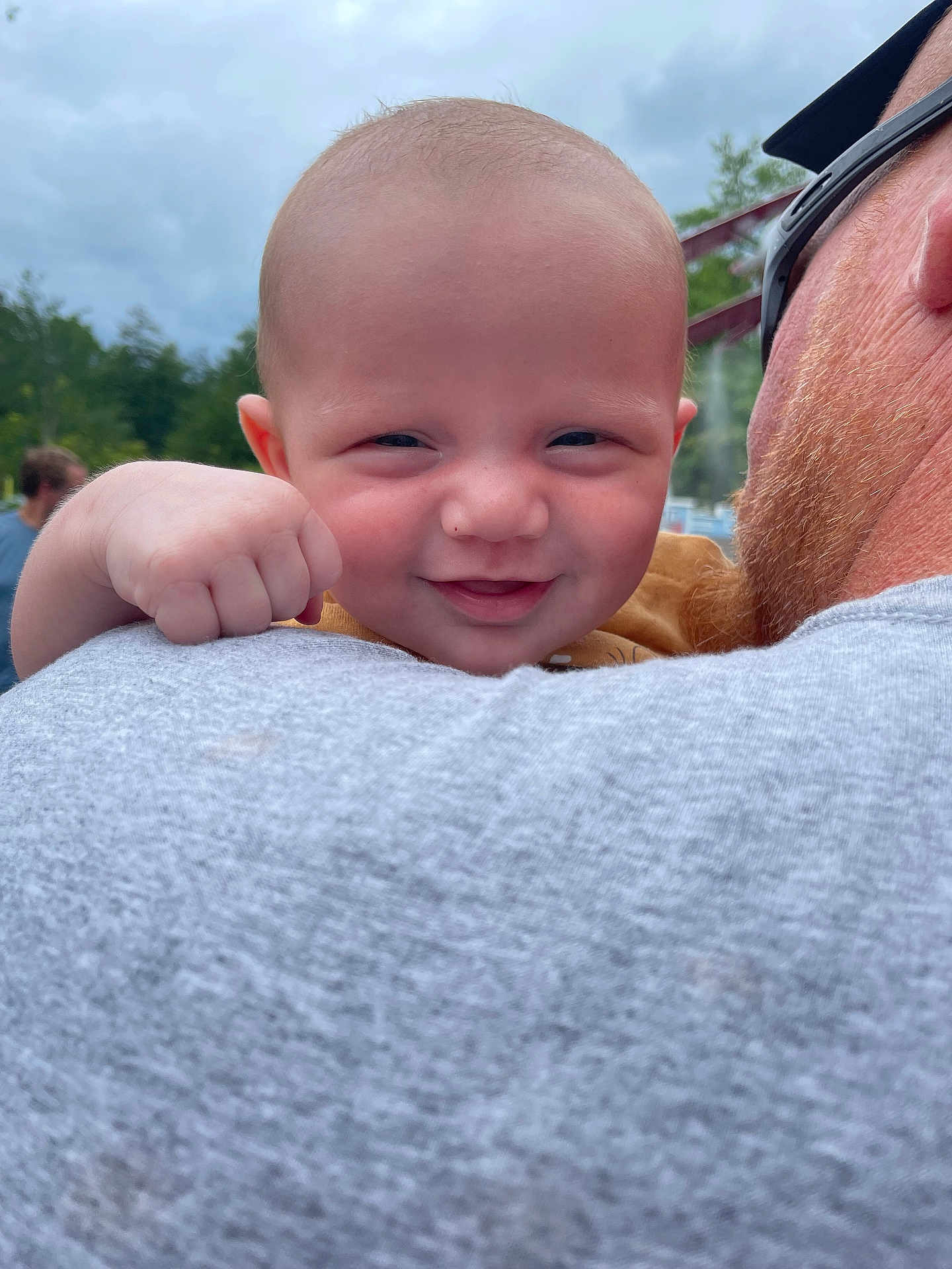 Ryett joined the competition — help win amazing prizes! adult, baby, casual_clothing, child, closeup, cloudy_sky, expression, face, fist, fun, hand, happy, head, nature, outdoor, person, portrait, shoulder, smile, trees