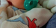 Ryett joined the competition — help win amazing prizes! baby, blanket, child, closeup, clothing, comfort, cozy, cute, face, indoors, infant, newborn, pacifier, pattern, person, resting, sleepy, soft, warm, wearing