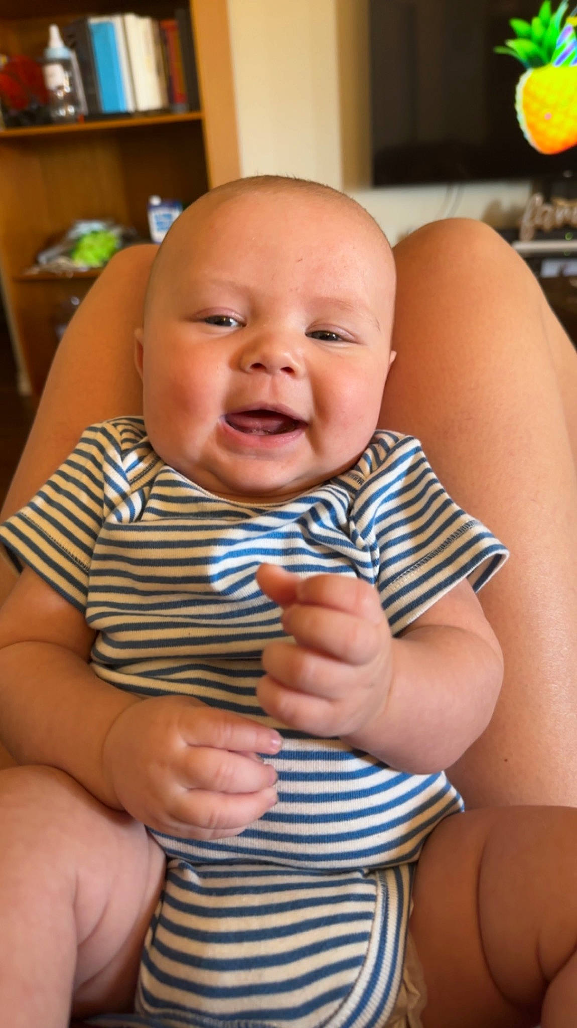 Jasper joined the competition — help win amazing prizes! baby, baby_toddler_clothing, bookcase, cheek, chin, eye, facial_expression, finger, gesture, happy, head, iris, person, shelf, skin, sleeve, smile, standing, thumb, toddler