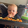baby, messy, food, pasta, high_chair, eating, child, indoor, meal, hands, face, legs, tray, living_room, furniture, clothing, expression, closeup, seat, background