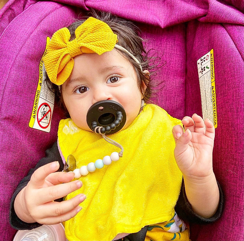 Kambry is registered to the contest to win money with this photo: baby, baby_toddler_clothing, cheek, chin, comfort, cool, eye, finger, gesture, head, headgear, headwear, jacket, mouth, nose, person, photograph, pink, skin, sleeve