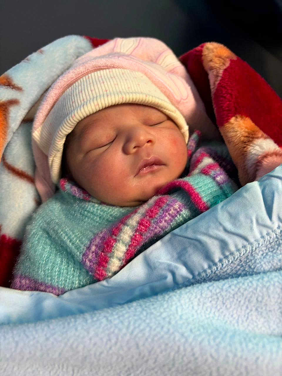 Coco joined the competition — help win amazing prizes! baby, newborn, sleeping, blanket, hat, cozy, warm, face, closeup, child, infant, soft, cute, wrapped, portrait, rest, peaceful, colorful, clothing, toddler