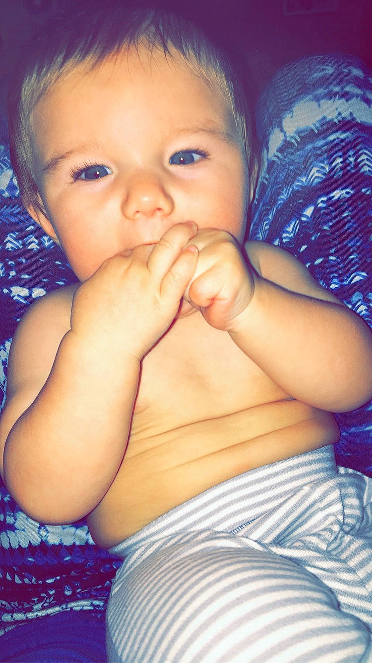 Collin is registered to the contest to win money with this photo: arm, baby, beauty, cheek, child, chin, close_up, eye, face, facial_expression, finger, head, iris, lip, mouth, nose, organ, person, skin, smile