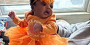 Kharia joined the competition — help win amazing prizes! baby, child, orange, tutu, headband, window, blinds, indoor, person, clothing, cute, infant, socks, floor, carpet, hand, sleeve, face, expression, holding