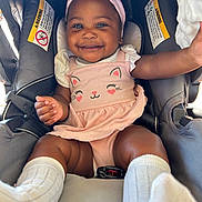 Tianna is registered to the contest to win money with this photo: baby, child, smiling, pink_outfit, headband, car_seat, white_socks, cute, happy, infant, portrait, indoors, seatbelt, toddler, clothing, girl, person, face, skin, baby_girl