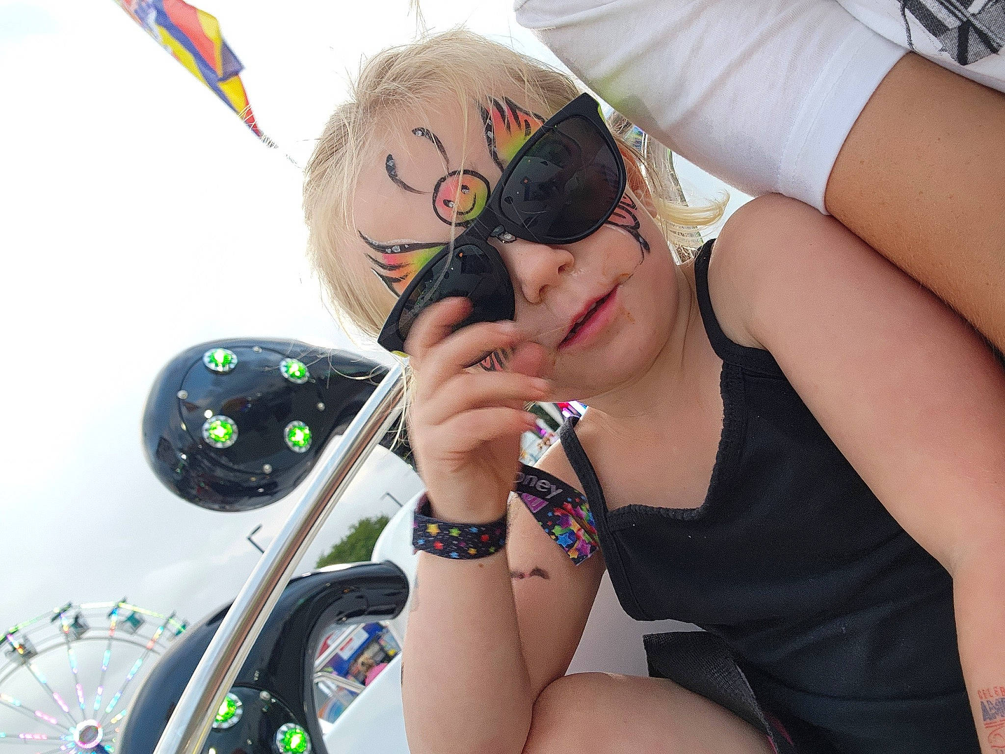 Mckenzie is registered to the contest to win money with this photo: arm, automotive_lighting, black_hair, cool, elbow, eyewear, finger, fun, gesture, goggles, happy, headgear, headwear, hood, leisure, nail, person, personal_protective_equipment, sports_equipment, thigh