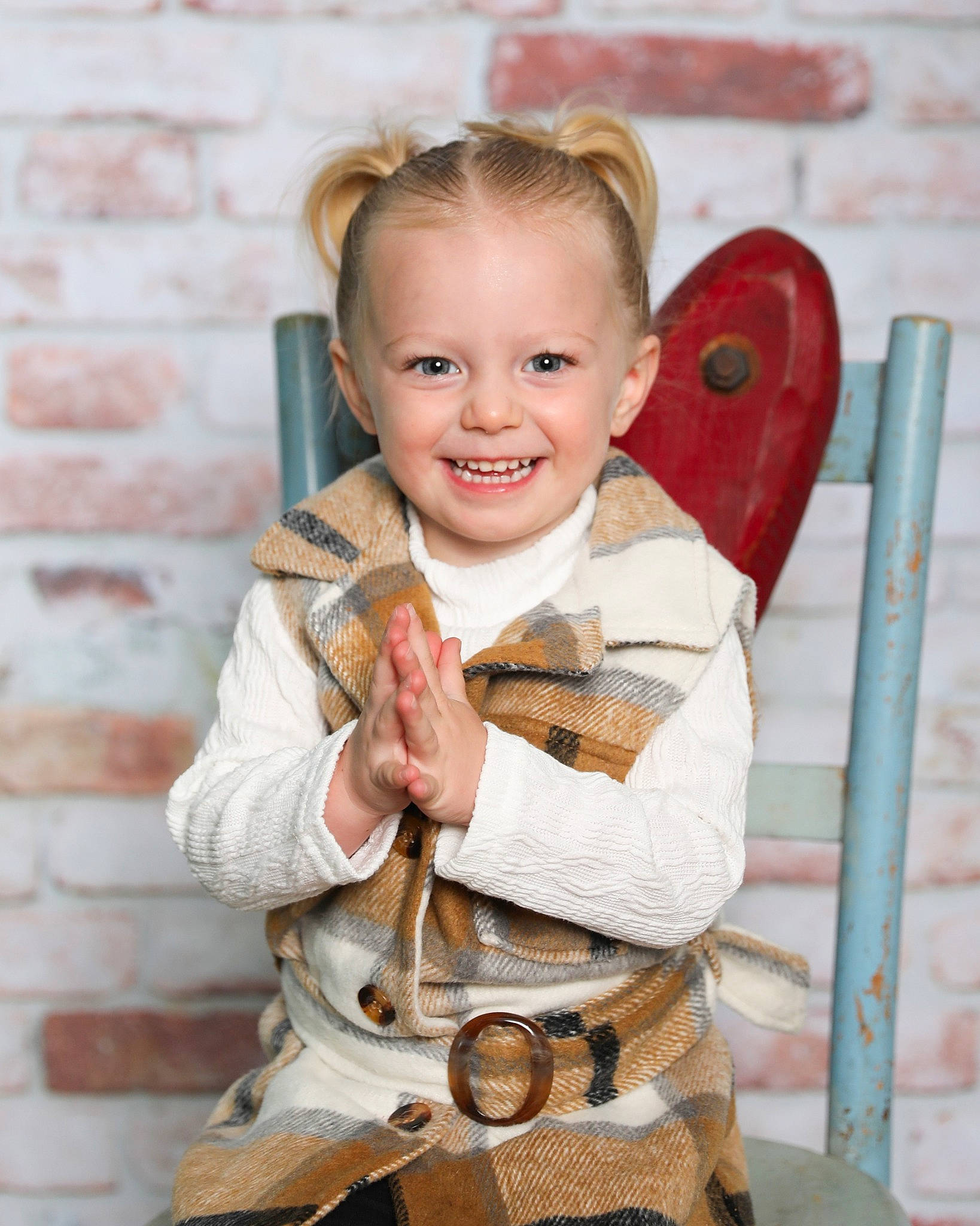 Mckenzie is registered to the contest to win money with this photo: baby, belt, brick, chair, child, costume, face, fashion_accessory, happy, head, jewellery, joy, orange, pattern, peach, person, sitting, sleeve, smile, toddler