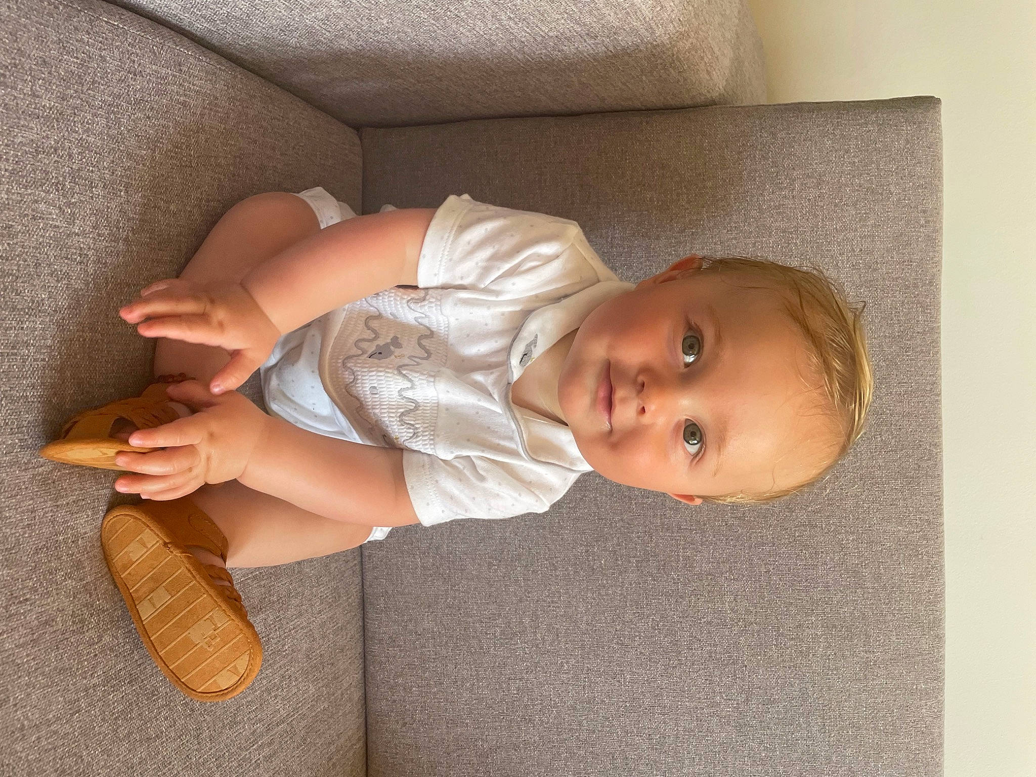 Haydn is registered to the contest to win money with this photo: arm, baby, baby_products, baby_toddler_clothing, child, comfort, fashion_accessory, finger, flooring, foot, hand, human_body, human_leg, joy, person, sitting, skin, sock, thumb, toddler