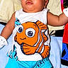 Jruziah is registered to the contest to win money with this photo: baby, blanket, blue_shorts, cartoon, casual, child, clothing, colorful, comfortable, cute, expression, face, indoor, infant, lying_down, nemo, small_hands, soft_texture, toddler, white_socks