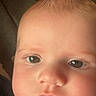 Joey is registered to the contest to win money with this photo: baby, close_up, face, infant, child, indoors, soft_light, blanket, curious, cheeks, portrait, young, cute, skin, expression, eyes, person, head, warm, cozy