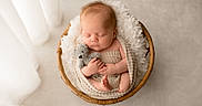 Phoenix is registered to the contest to win money with this photo: newborn, baby, sleeping, teddy_bear, blanket, basket, wicker, fluffy, cozy, indoor, soft_light, peaceful, cute, child, portrait, infant, wrapped, resting, adorable, nursery