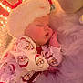 Tommie is registered to the contest to win money with this photo: baby, sleeping, pajamas, santa_claus, hat, soft_lighting, holiday, christmas, infant, cute, cozy, blanket, face, child, indoors, festive, warm, relaxed, portrait, holiday_decor