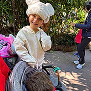 Girl joined the competition — help win amazing prizes! boy, casual_clothing, child, daylight, family, girl, greenery, happy, hat, hoodie, jacket, outdoor, park, person, plants, playful, smile, stroller, walking, white_hat