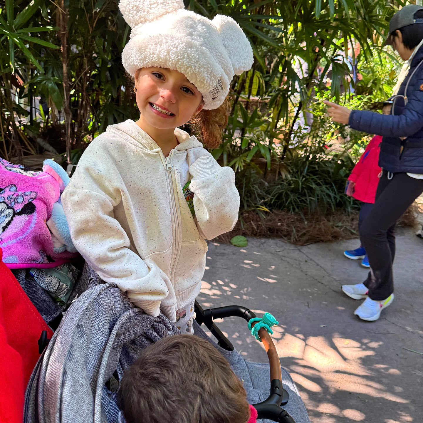 Girl joined the competition — help win amazing prizes! boy, casual_clothing, child, daylight, family, girl, greenery, happy, hat, hoodie, jacket, outdoor, park, person, plants, playful, smile, stroller, walking, white_hat
