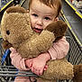 Lilly is registered to the contest to win money with this photo: toddler, child, plush_toy, shopping_cart, aisle, store, pink_jacket, toy_duck, cute, shopping, hands, face, eyes, indoor, retail, clothing, childhood, holding, curious, supermarket