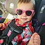 toddler, child, sunglasses, car_seat, car, seatbelt, plaid_shirt, hand, thumbs_up, face, person, safety, child_seat, sunlight, interior, cute, smile, young_child, fashion, accessory