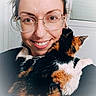woman, person, cat, calico_cat, pet, selfie, portrait, smiling, glasses, long_hair, animal, furry, tricolor, black_fur, orange_fur, white_fur, indoors, close_up, companionship, happy
