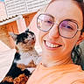 Vénus participe au concours pour gagner de l'argent avec cette photo : woman, cat, calico_cat, selfie, portrait, smiling, glasses, outdoor, sunlight, orange_shirt, face, whiskers, fur, pet, companion, rooftop, house, fence, blue_sky, photography