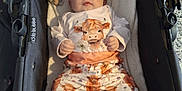 Autumn-Rose is registered to the contest to win money with this photo: baby, infant, stroller, plush_toys, headband, cute, clothing, animal_print, cow, soft_lighting, cozy, blanket, indoor, child, portrait, white_socks, toy, fabric, relaxing, comfort