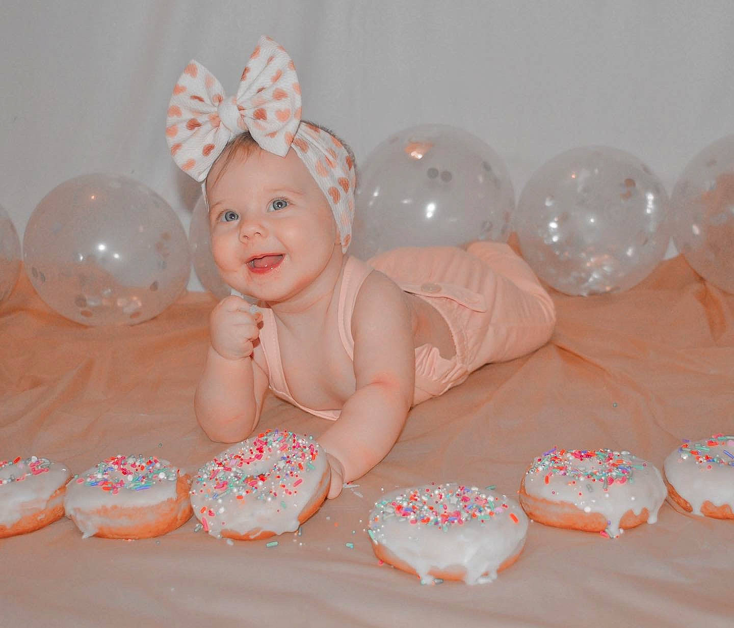 Oakley is registered to the contest to win money with this photo: baby, baby_toddler_clothing, baking, cake_decorating_supply, child, dessert, event, food, hair_accessory, happy, headpiece, headwear, icing, party, party_supply, person, pink, smile, sugar_cake, sweetness