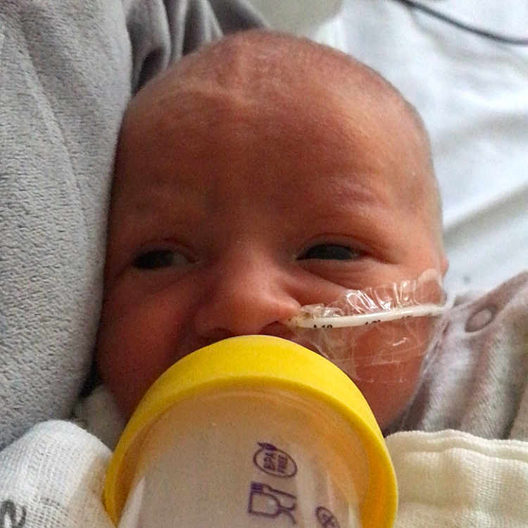 Charlie is registered to the contest to win money with this photo: architecture, baby, bed, beverage, blanket, bodypart, bottle, building, cup, face, finger, furniture, head, hospital, milk, newborn, person, photography, portrait, sleeping