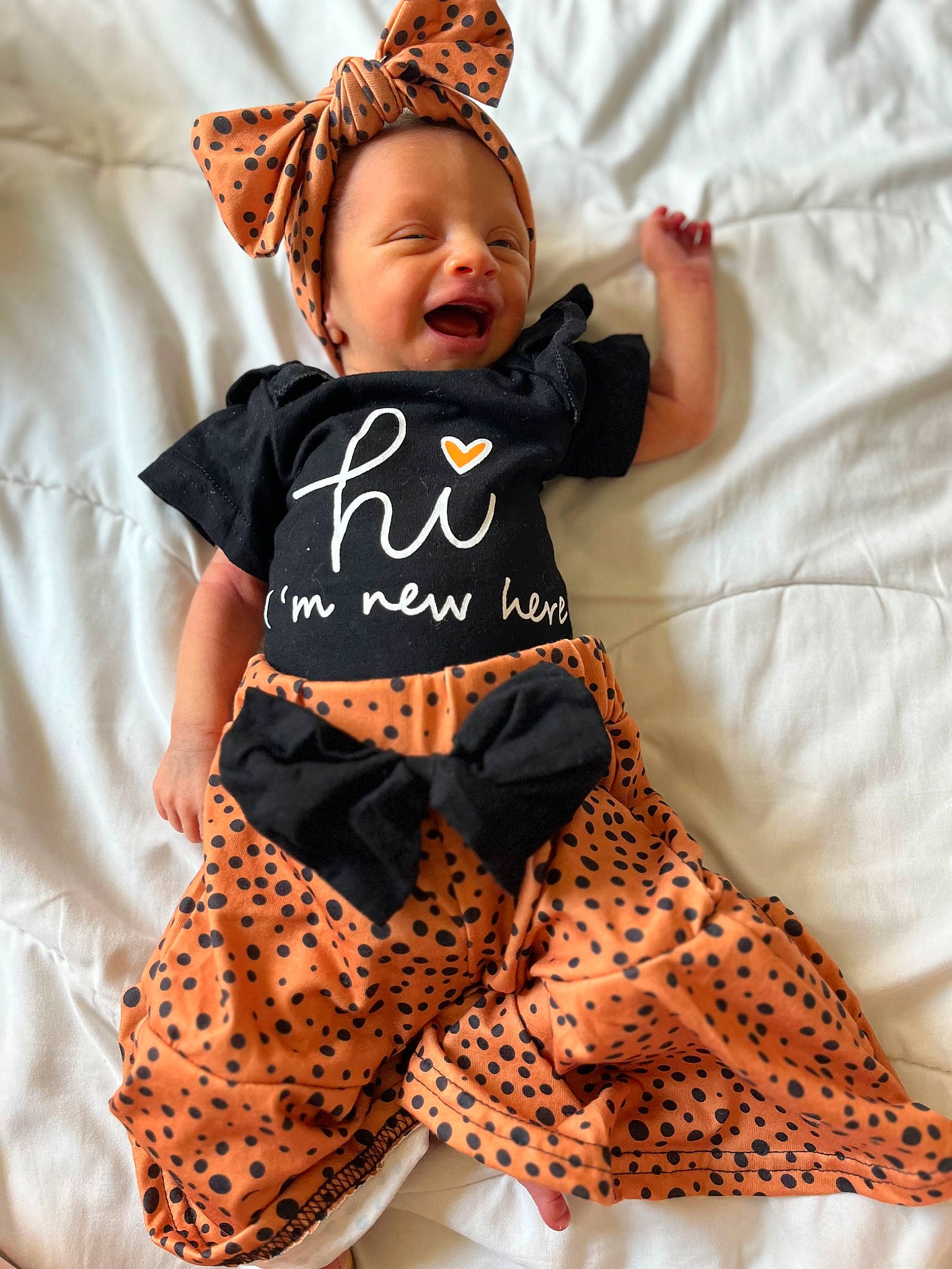 Miabella joined the competition — help win amazing prizes! baby, baby_toddler_clothing, child, comfort, costume_hat, fashion_accessory, happy, hat, headband, linens, orange, pattern, peach, person, sleeve, smile, t_shirt, textile, thigh, toddler