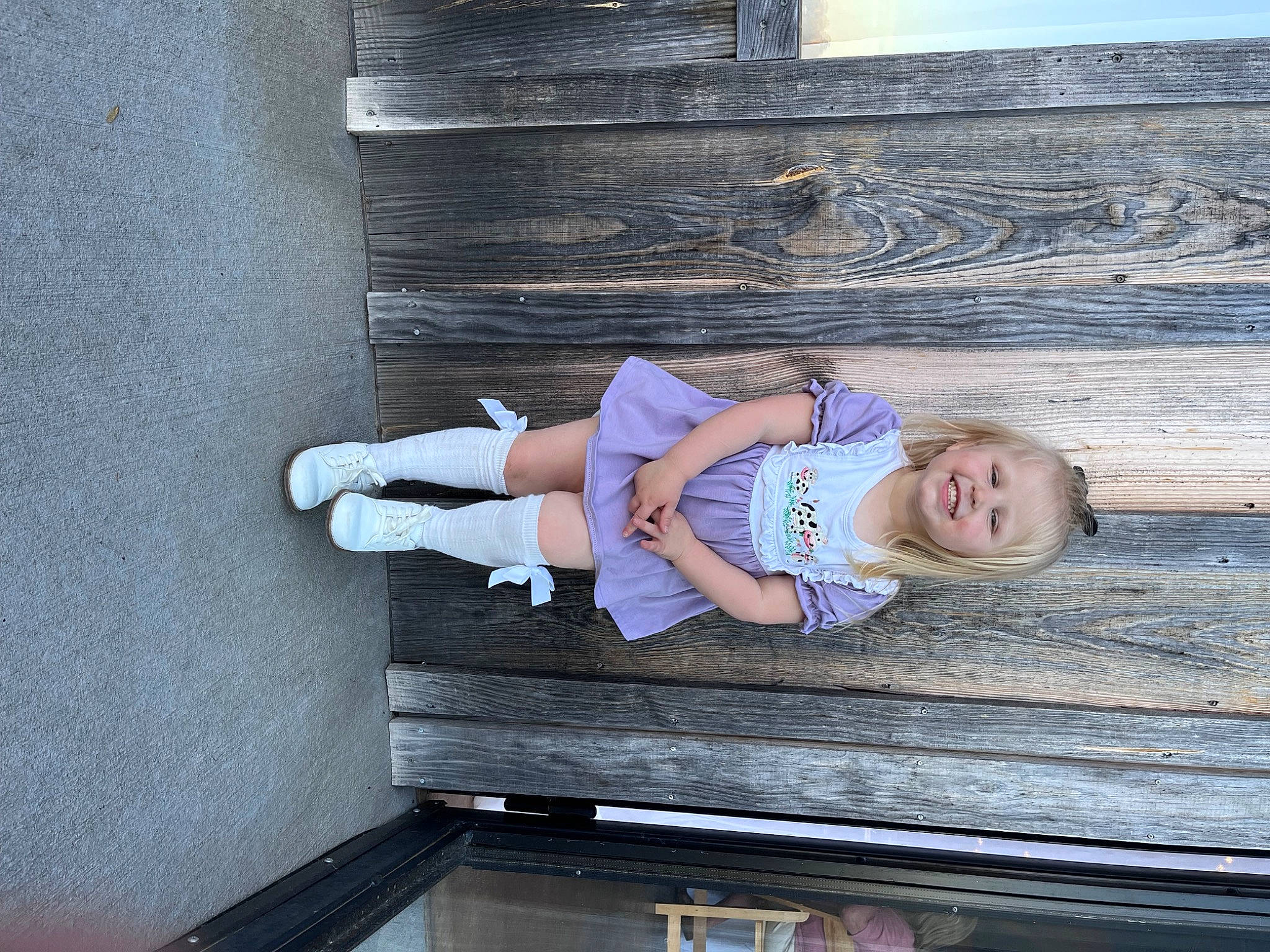 Addy is registered to the contest to win money with this photo: baby_toddler_clothing, child, comfort, denim, electric_blue, fun, hardwood, hat, human_leg, joy, knee, leisure, person, sandal, sitting, smile, standing, t_shirt, thigh, toddler