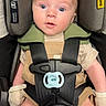 baby, blue_eyes, car_seat, child, closeup, clothing, curious, cute, face, harness, head_support, indoor, infant, mittens, pacifier, person, safety, seatbelt, striped, young