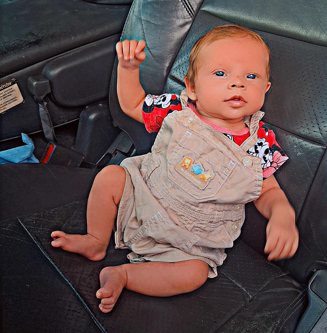 Nova is registered to the contest to win money with this photo: baby, bodypart, car, chair, clothing, couch, cushion, doll, face, finger, furniture, hand, head, homedecor, pants, person, photography, toy, transportation, vehicle
