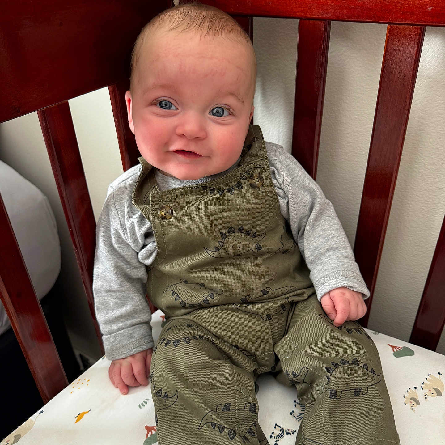 Beckett is registered to the contest to win money with this photo: baby, bodypart, clothing, couch, crib, cushion, dress, face, finger, furniture, hand, head, homedecor, infantbed, jeans, pants, person, photography, portrait, sitting