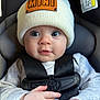 Hazel is registered to the contest to win money with this photo: baby, child, infant, hat, knit_hat, car_seat, seatbelt, straps, clothing, hands, face, eyes, cute, portrait, indoor, closeup, baby_fashion, infant_care, person, young_child