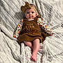 Hazel joined the competition — help win amazing prizes! baby, child, headband, bow, dress, pumpkin, thanksgiving, blanket, soft_texture, cute, infant, clothing, patterned_sleeves, lying_down, indoors, portrait, smile, face, legs, foot
