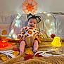 autumn_leaves, baby, blanket, child, costume, cute, decorations, festive, glowing_lights, halloween, happy, headband, holiday, indoors, orange, pumpkin, skeleton, smiling, spider_web, yellow