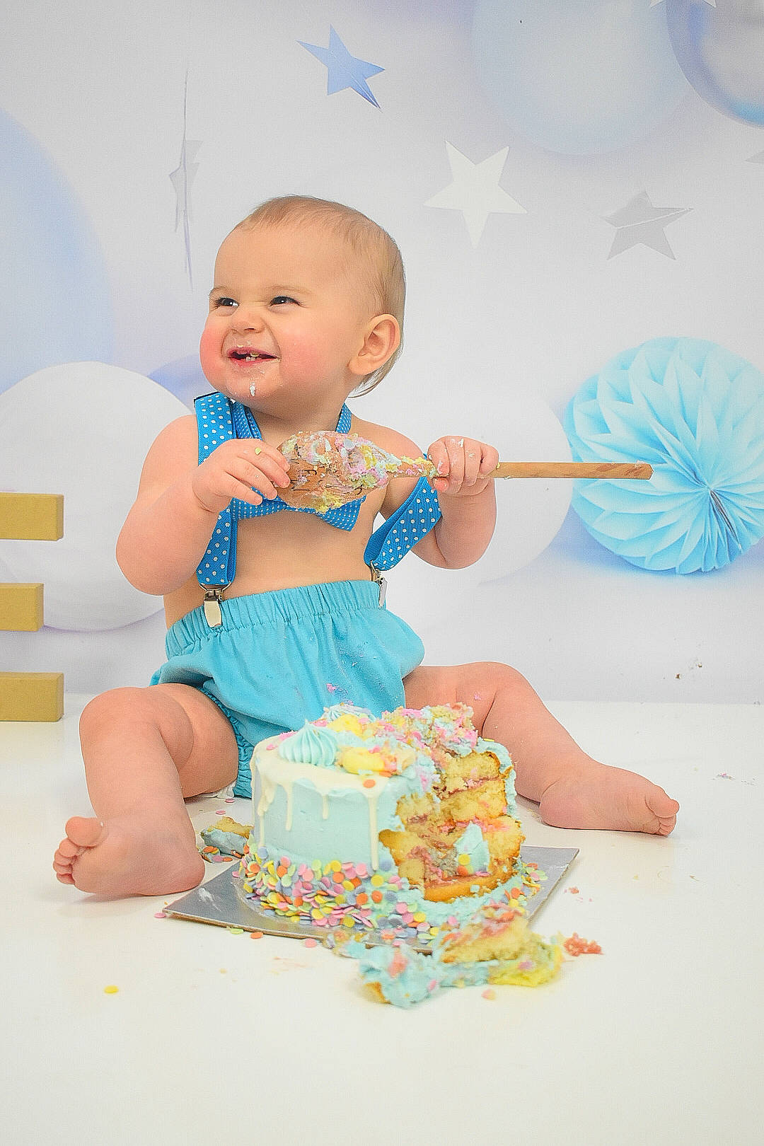 Bowden is registered to the contest to win money with this photo: aqua, baby, baby_products, baby_toddler_clothing, baby_toys, child, event, finger, fun, happy, icing, joy, nail, party_supply, person, play, sitting, smile, sugar_cake, sweetness